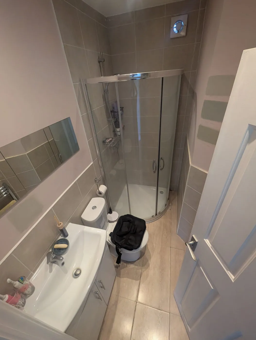 Lille Road shower room before, with curved chrome enclosure and beige tiles