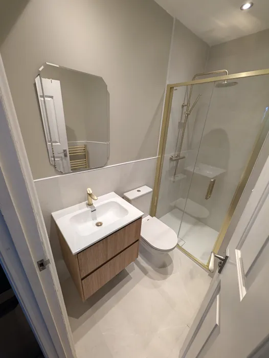Lille Road shower room with brushed-brass shower and fluted vanity