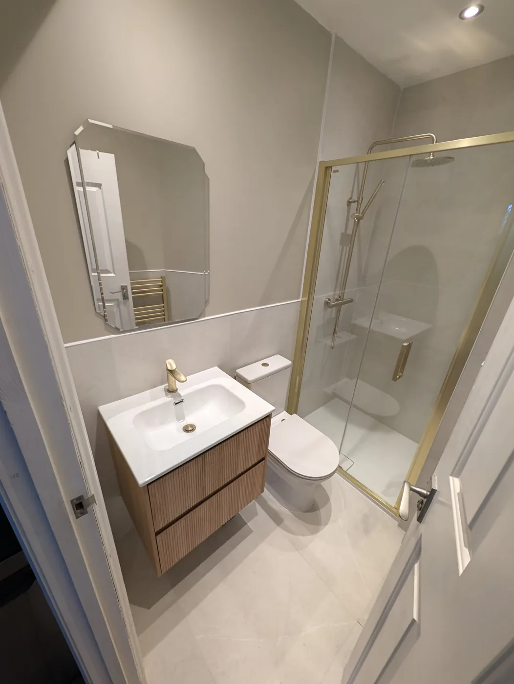 Lille Road shower room after, with brushed-brass shower and fluted vanity