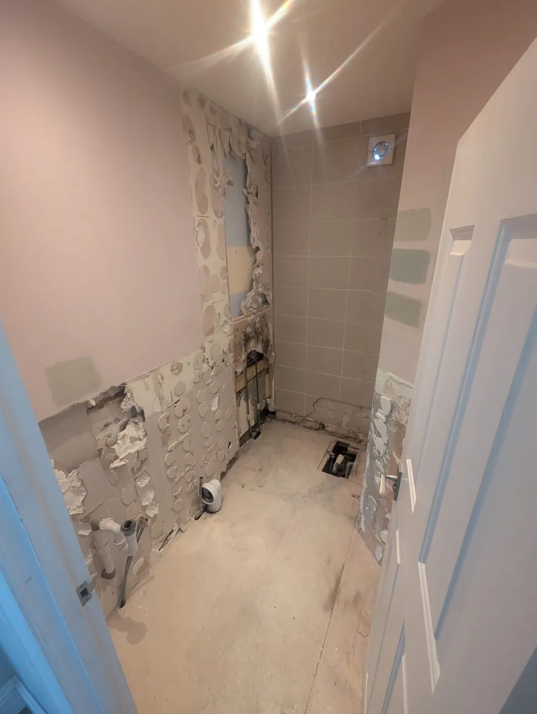 Lille Road room stripped back with old waste pipes exposed