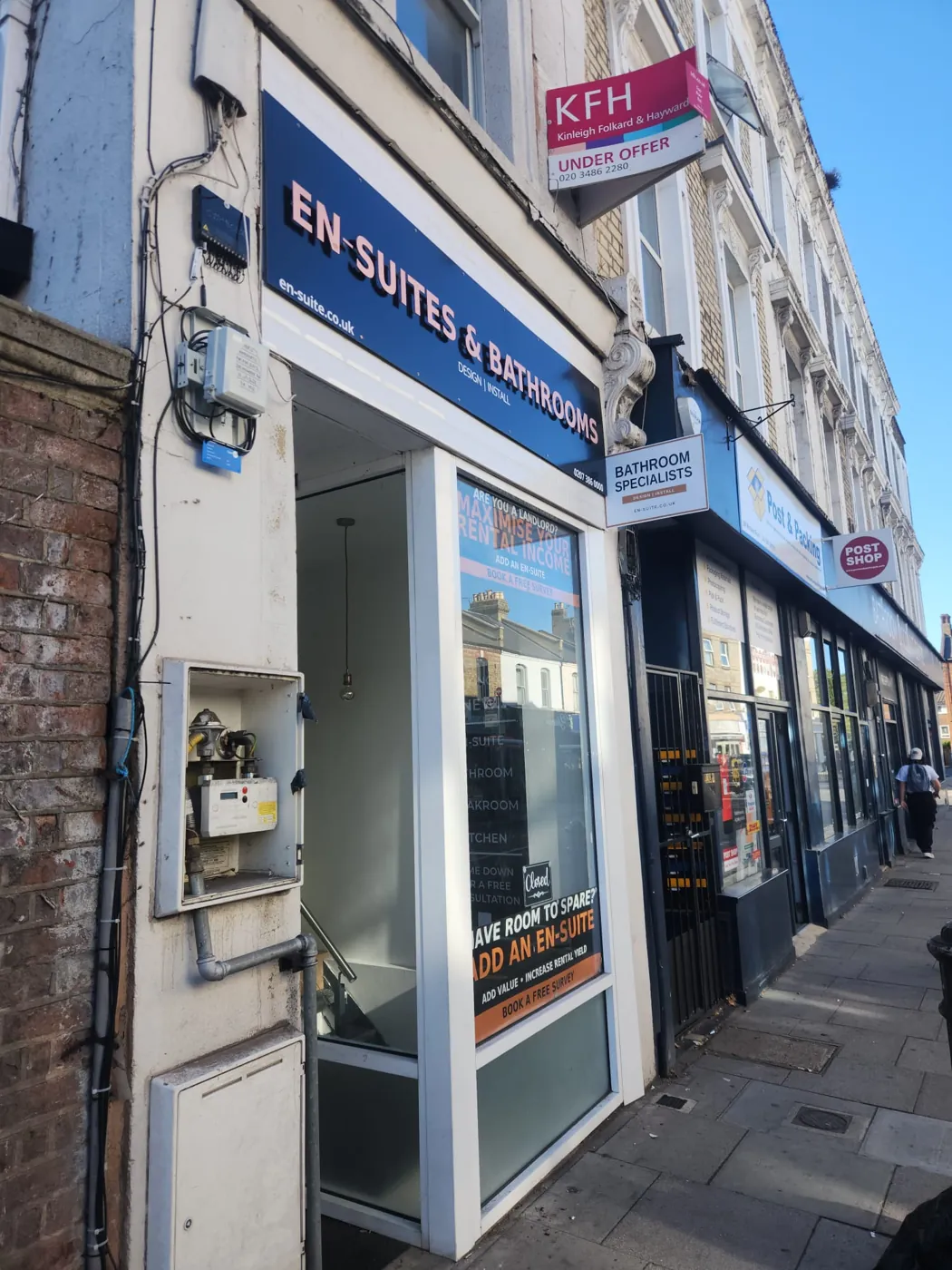 En-Suites & Bathrooms shop on Munster Road, Fulham, with neighbouring shops along the street